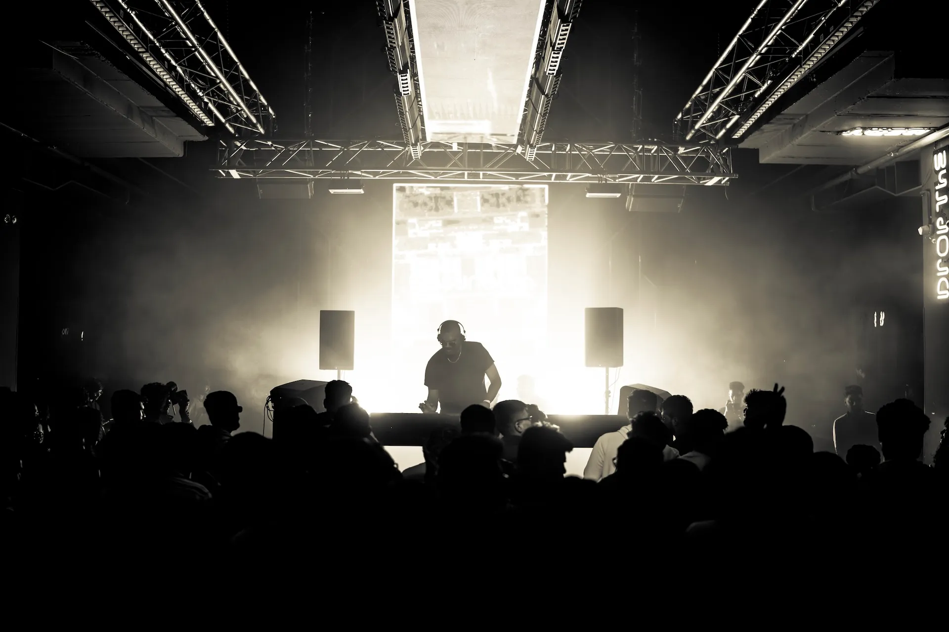 Raka Ashok performing, silhouette in light and fog